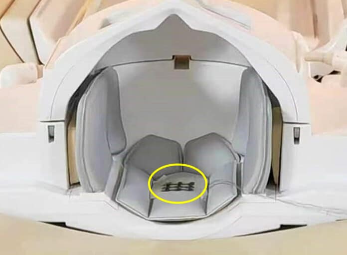 the self-powered sensor (circled in yellow) attached to a headrest within an MRI machine