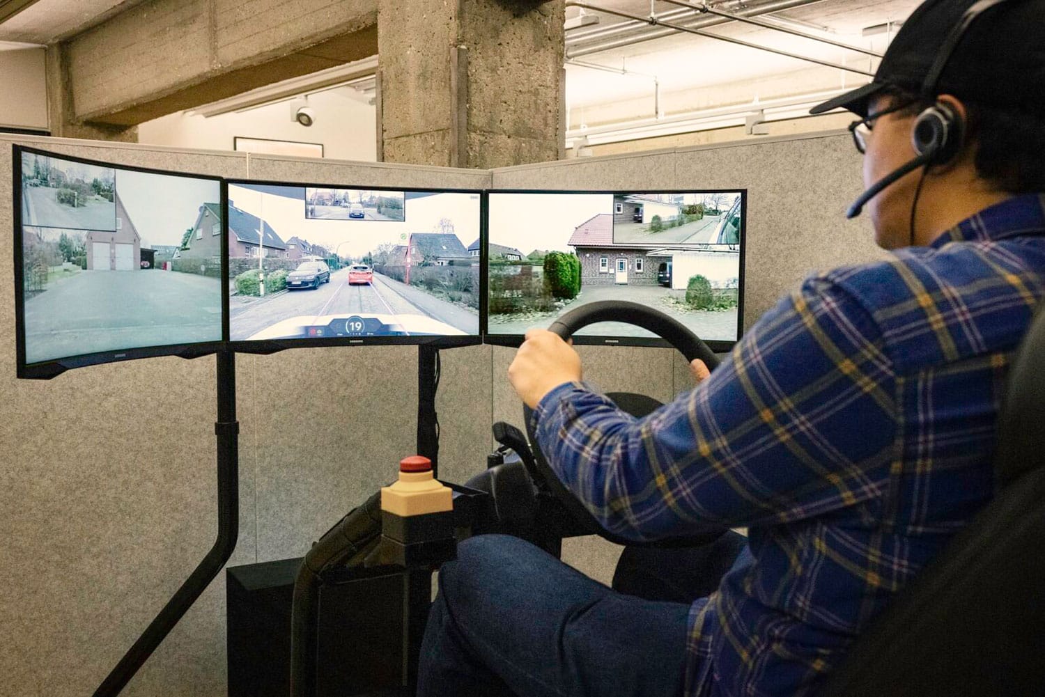A Vay driver operates a vehicle remotely from a control center that features multiple video feeds. Tele-driving could offer many of the efficiencies that autonomous vehicles are expected to provide, according to research at U-M.